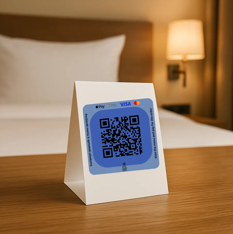 A QRandPay table stand in a hotel room